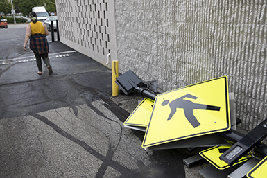 person walking past walk signs
