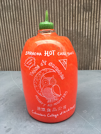 Glass Sriracha hot sauce bottle made by CCAD students