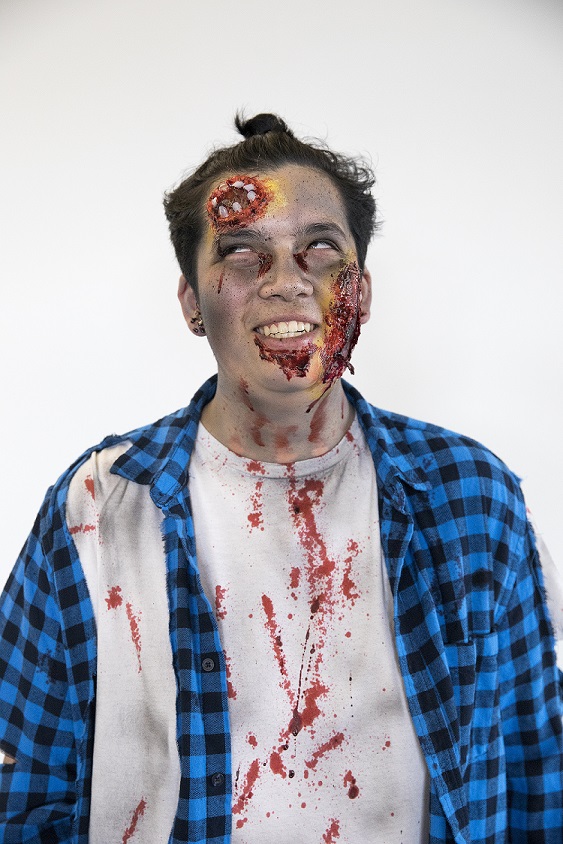 person in zombie makeup in blue plaid