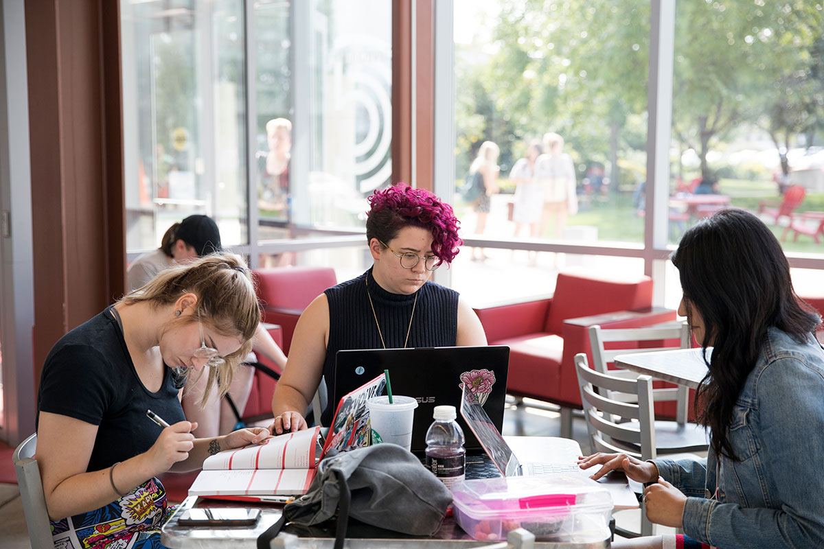 three students studying