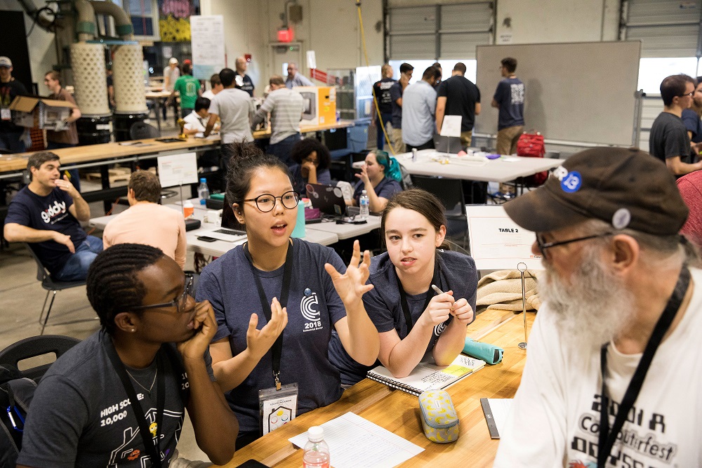 students at hackathon talking