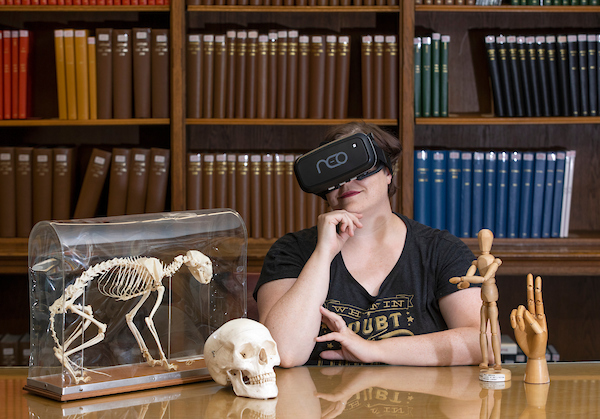 CCAD Director of Library Services Leslie Jankowski models unusual library items