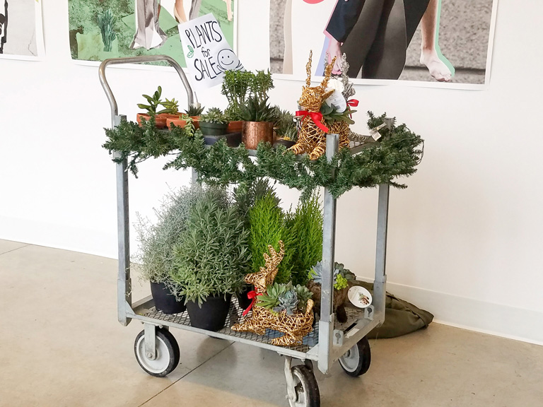 Master of Design, Plants on a cart, with "Plants for sale" sign.