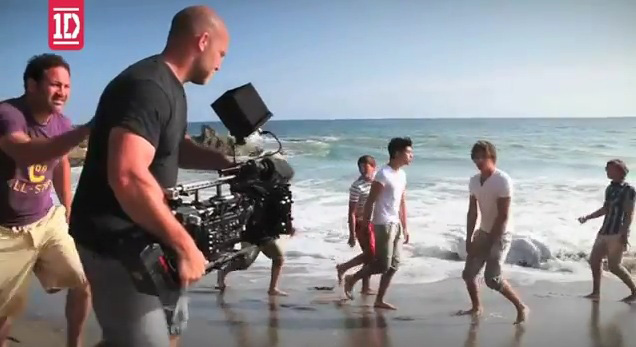 Advertising & Graphic Design, Image of John holding camera behind the scenes of One direction music video shoot on the beach