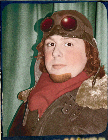 Illustration, Painted portrait of a man, not smiling, in old pilot's goggles and brown, fur trimmed leather jacket