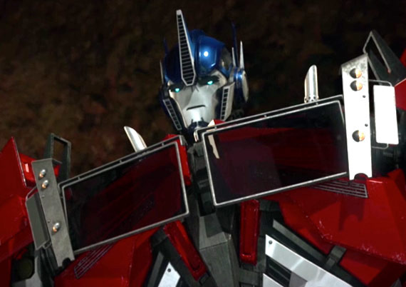 Illustration, Close up image of red, blue, and white Transformer robot at night, with glowing green eyes