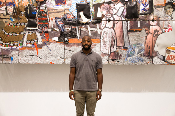 Fine Arts, Image of Aaron Fowler in gray polo standing in front of large painting made up of many square panels at CCAD's Beeler Gallery