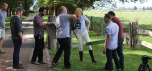 Advertising & Graphic Design, John Urbano working with models outdoors on side of rustic dirt road surrounded by camera crew