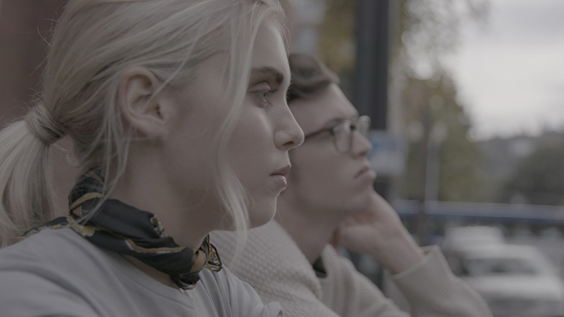 Film & Video, Still Image from film Back to You featuring man and woman sitting next to each other in silence staring out in the same direction