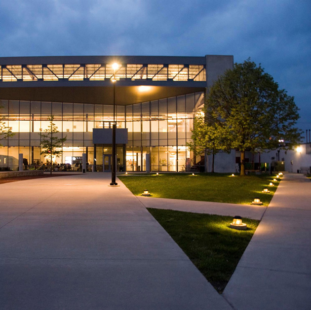 Life at CCAD, Image with view of the Quad and Loann Crane Center for design lit up at night against a dusky deep blue sky 