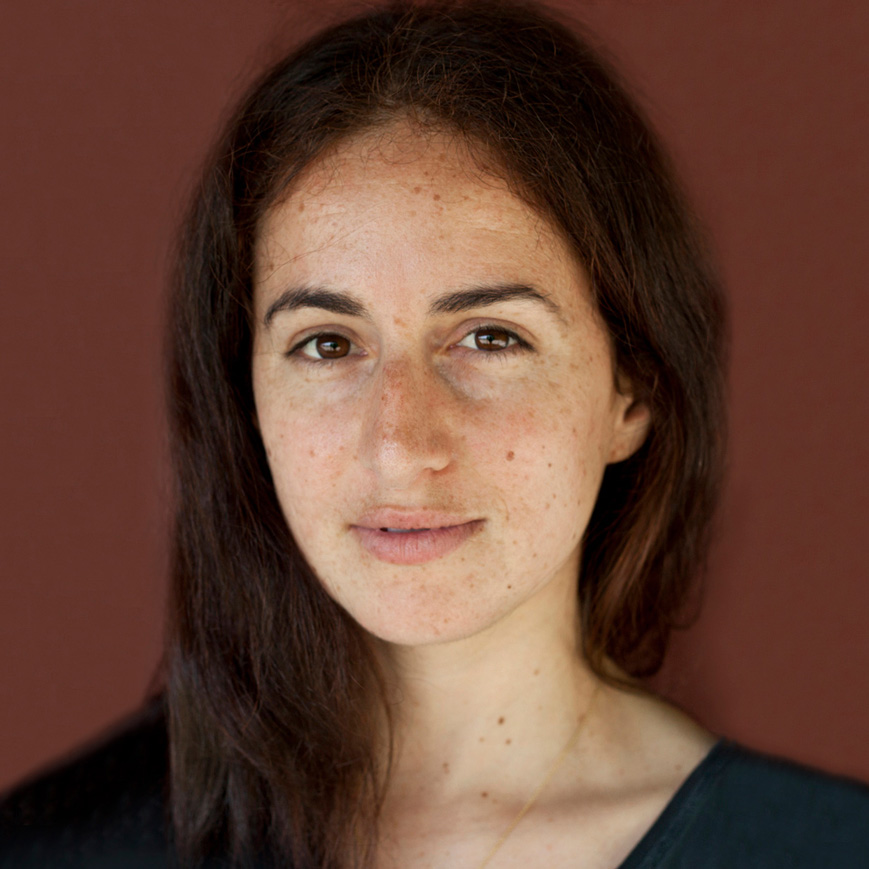 Photography, Headshot of Carmen Winant against a brown background with dark hair falling over shoulder. Not smiling, facing camera