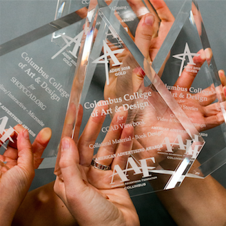 Advertising & Graphic Design, Image of three hands holding three glass awards