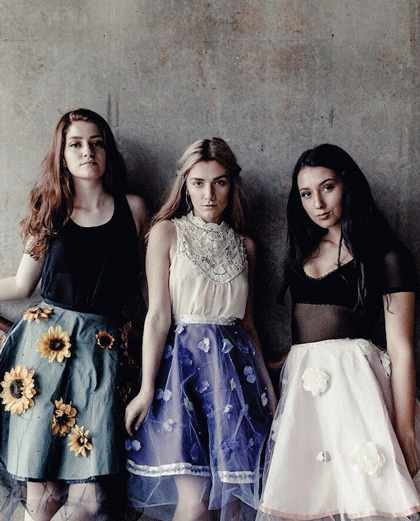 Fashion Design, Three models in floral skirts against a gray wall