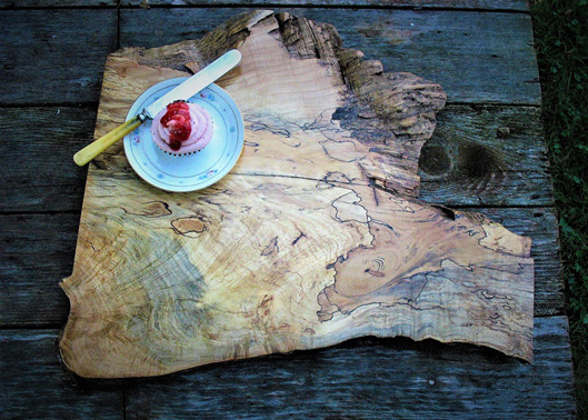 Interior Design, Rustic wooden serving board on wooden table with pink cupcake on a plate