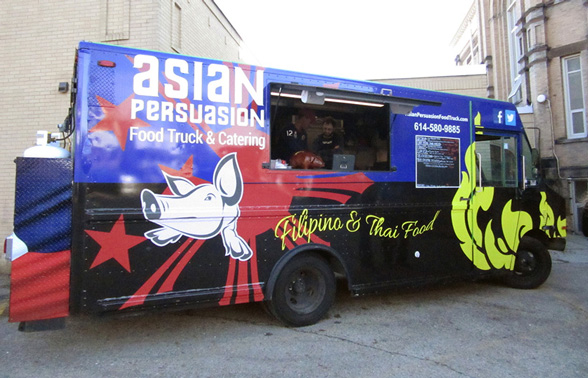 Life at CCAD, Image of parked blue,yellow, black, and red food truck with illustration of pig on the side, text reads "Asian Persuasion Food Truck & Catering"