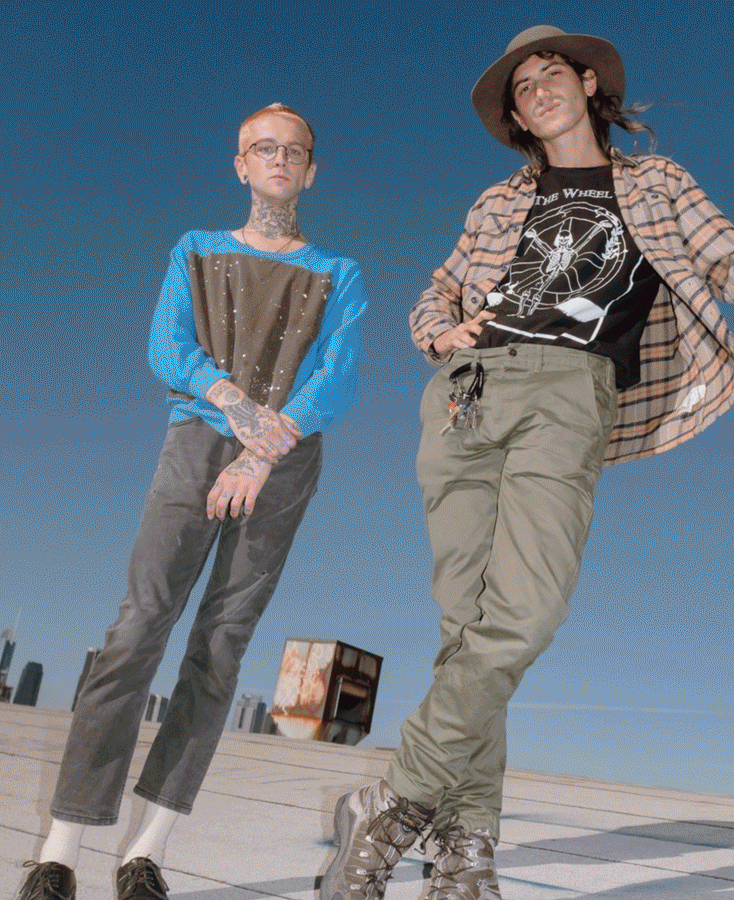 Fine Arts, Alix Ross and Elijah Funk pose for photo standing against backdrop of blue sky