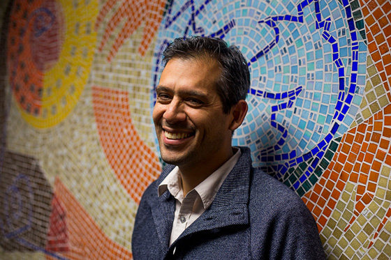 Advertising & Graphic Design, Headshot of Jeremy Rosario standing in front of colorful wall of tile mosaic