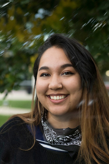 Illustration, Animation, Close up headshot of CCAD student Khalia Carr (Illustration, 2018) on The Quad with trees in the background