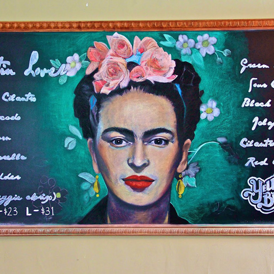 Fine Arts, Chalk Portrait of Frida Kahlo in pink flower crown surrounded by green glow for Yellow Brick Pizza