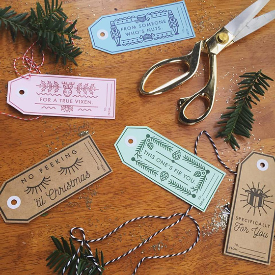 Advertising & Graphic Design, Image of gift tags scattered across a table with striped cord and bits of pine branches on a wooden table