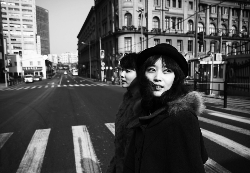 Master of Fine Arts, Black and white image of two women crossing cross walk in Shanghai