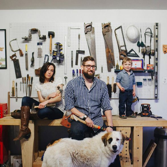 Industrial Design, Interior Design, Photo of Cori, Benjamin, toddler son, and large dog posing for photo in workshop among tools against a backdrop of tools hanging from a white peg board