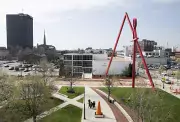 Shot of students standing next to cone, wide shot of campus