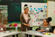 Maurshell interacts with other student at work table