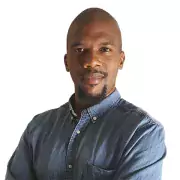 Headshot of Alfredo weeks in a denim button down, serious expression