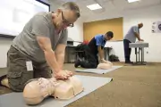 person gives cpr to training dummy
