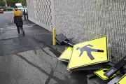 person walking past walk signs