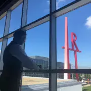 student and art sign in window