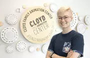 CCAD grad Erica Eppert (Illustration, 2018) stands in front of the donor wall she created