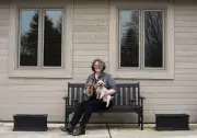 charlotte belland on front porch with dogs