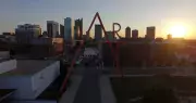 CCAD's iconic 100' tall ART sculpture backlit against the Columbus skyline