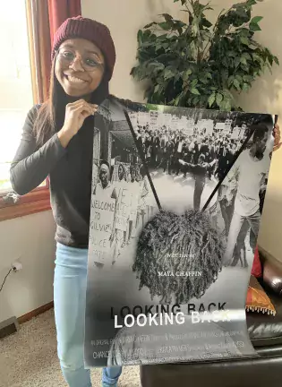 maya chaffin holding movie poster