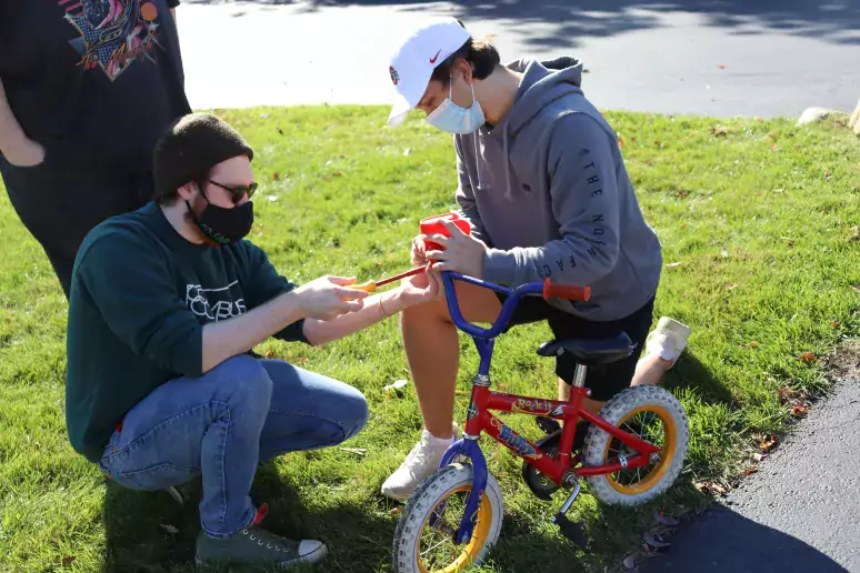 two people kneeling at bike