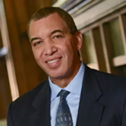 Jerry O. Allen in black suit, blue shirt, and black patterned tie