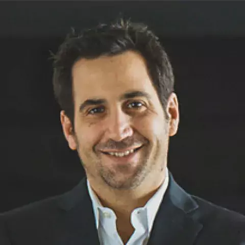 Headshot of Andrew R. Summerfield in black suit jacket and white buttoned shirt against a black background