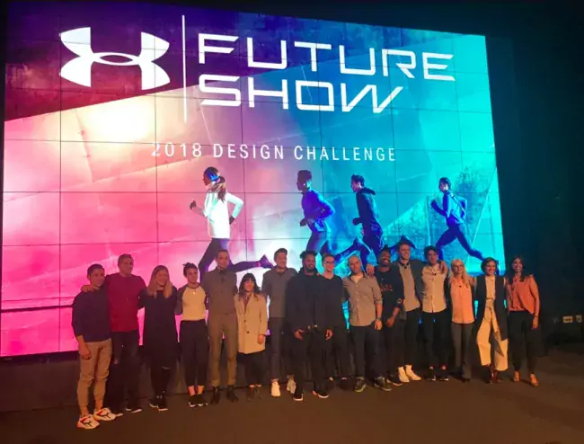 group photo in front of UA future show banner